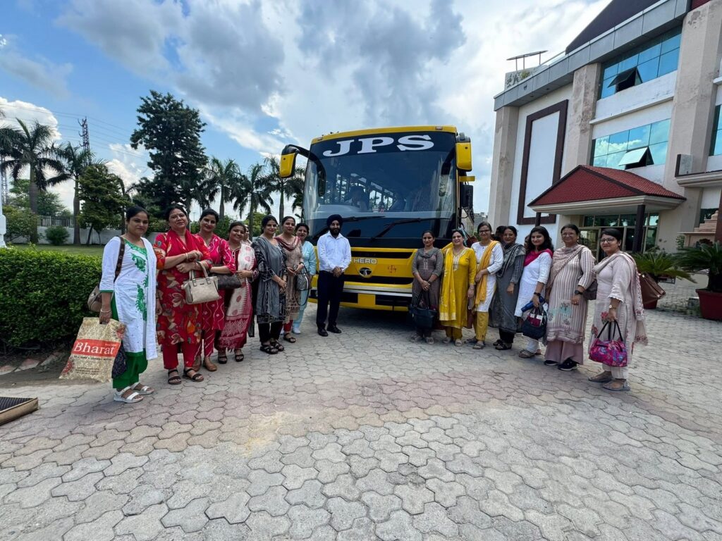 JPS Academy staff with the air-conditioned bus on the Karnal route